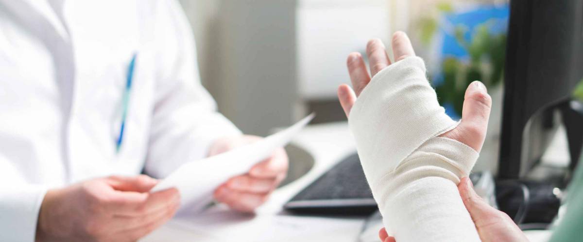 Injured patient showing doctor broken wrist