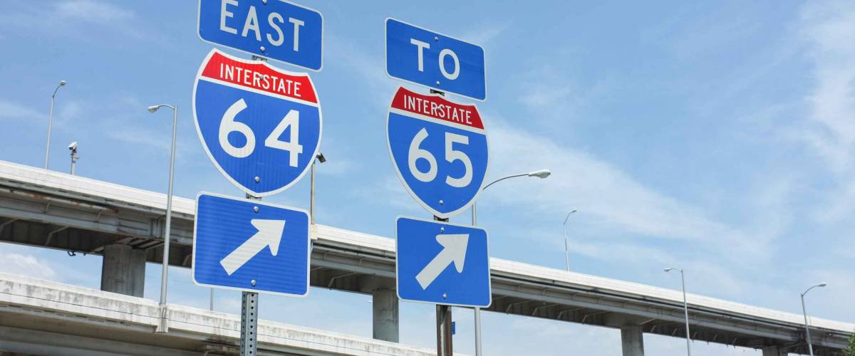 Signs for interstate highways I-64 and I-65 in Louisville, Kentucky. Symbolizes transportation, infrastructure, travel.
