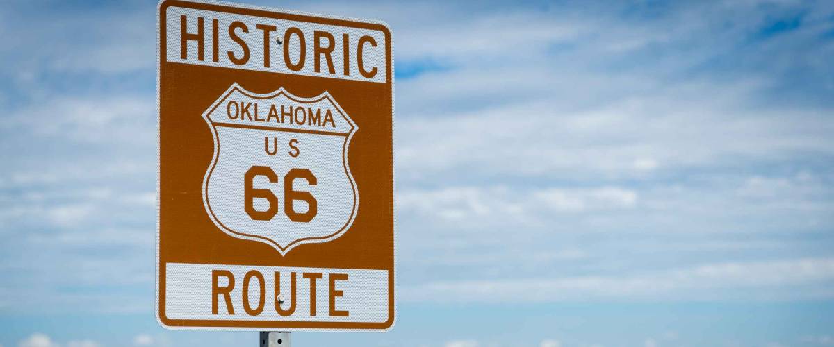 Historic brown and white sign on US Route 66 in Oklahoma