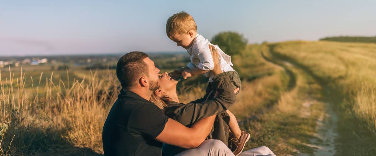 Parents and son in a field