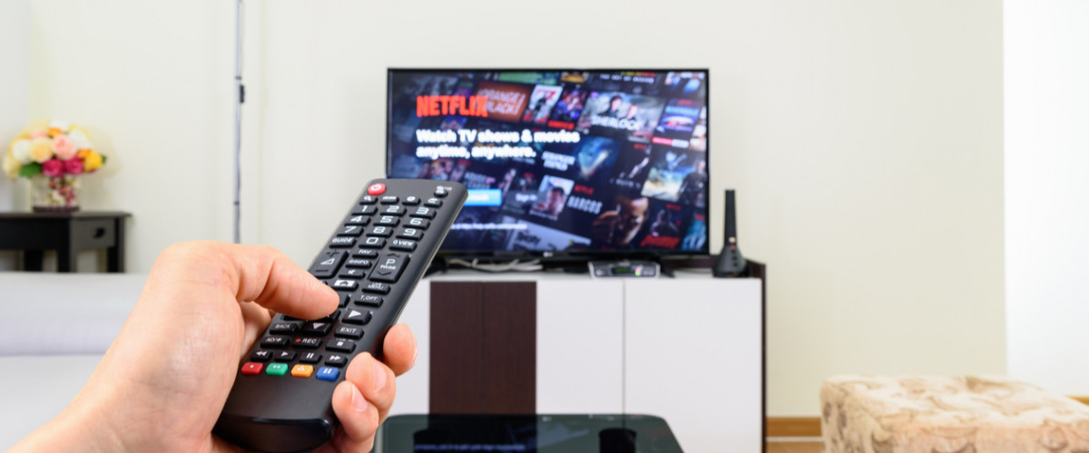 Netflix on a television with remote in foreground