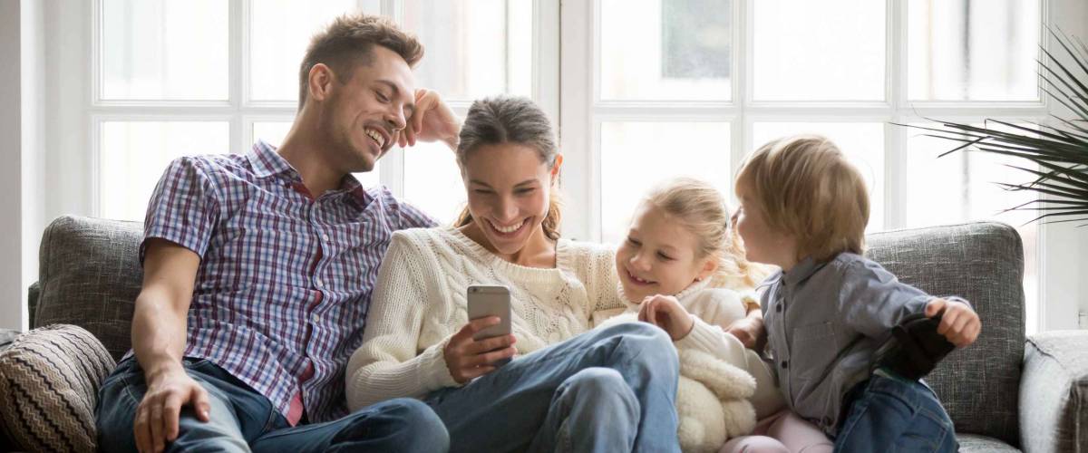 Cheerful young family with kids, needing life insurance