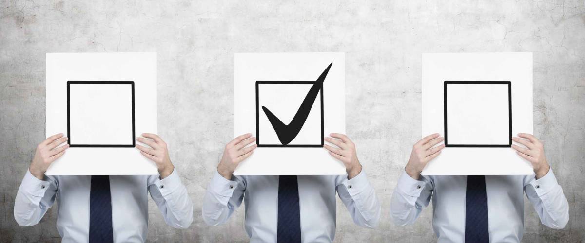 Three businessmen are holding a check boxes, a concept of decision making process.