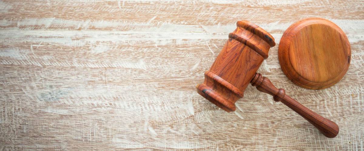 wooden gavel on top of wooden desk. auctions concept.