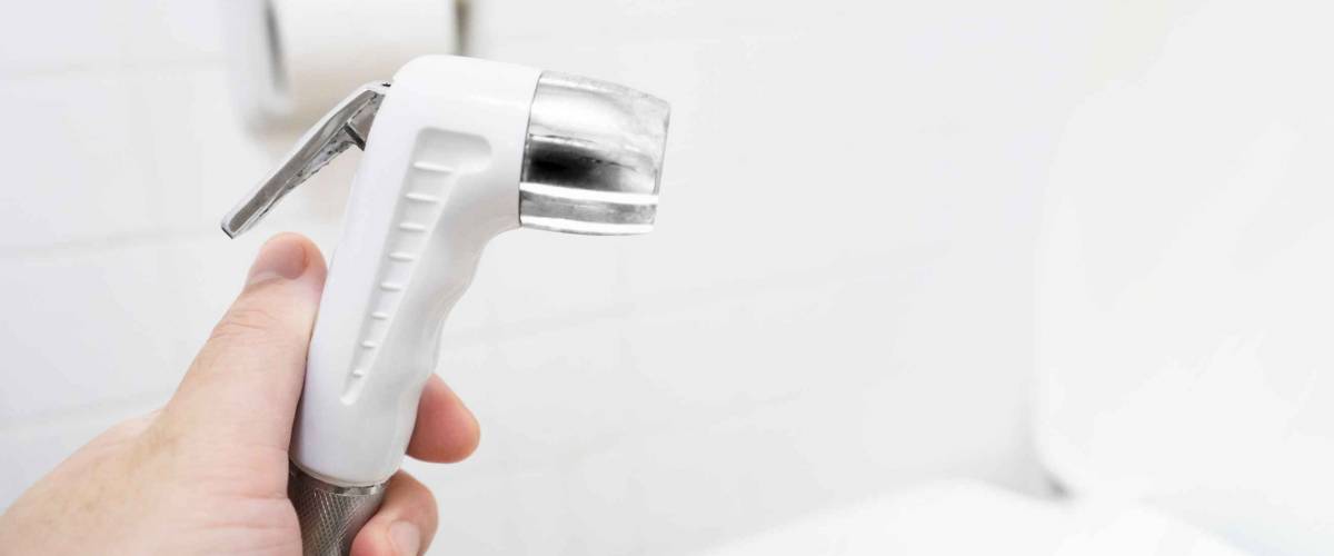 Handheld bidet. Commercial space background concept for