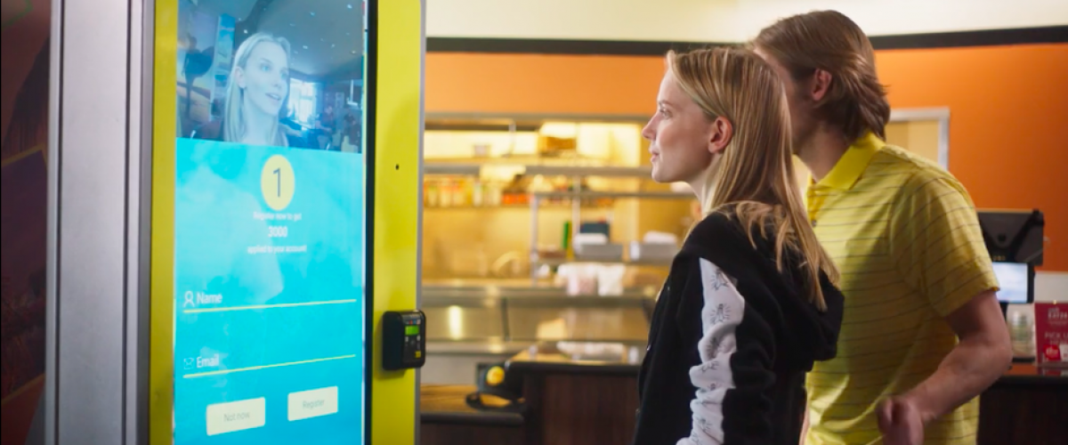 Young couple uses the facial recognition kiosk at CaliBurger.