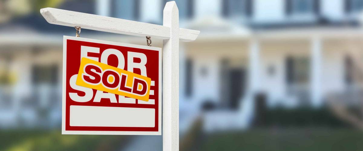 Sold Home For Sale Real Estate Sign in Front of Beautiful New House.