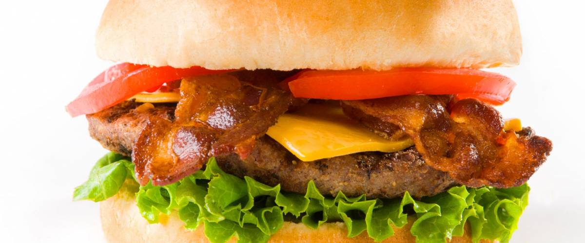 A delicious Bacon Cheese Burger on white