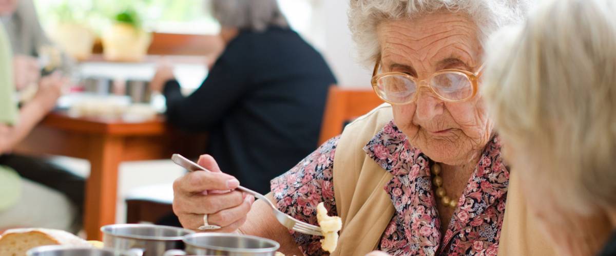 senior woman eating her lunch at home