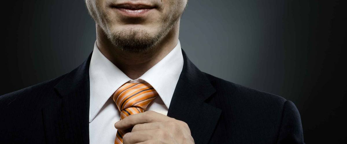 portrait the beautiful businessman in black costume tie one's necktie