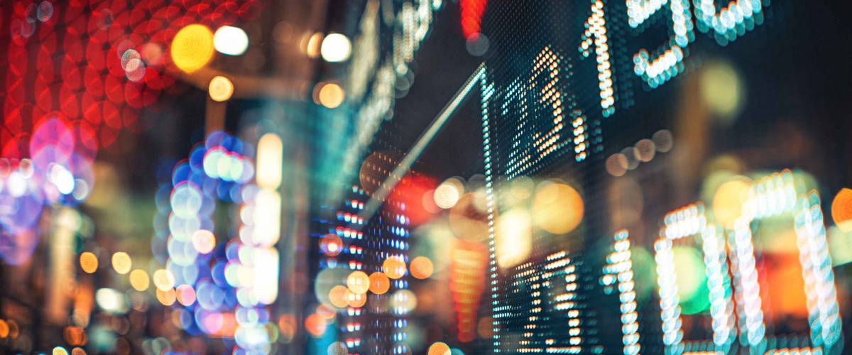 Display of Stock market quotes with city scene reflect on glass