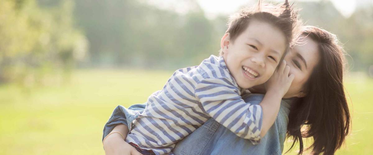 Mother and son in the field. Happy family life style concept.