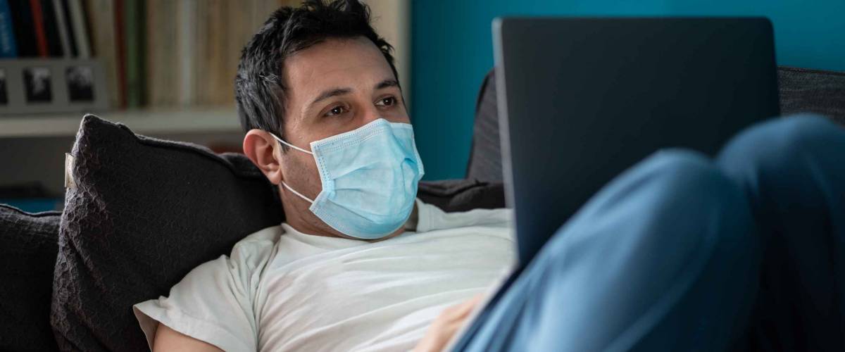 A white man is working from home during Coronavirus or Covid-19 quarantine, coronavirus covid 19 infected patient in coronavirus covid 19 quarantine room using computer