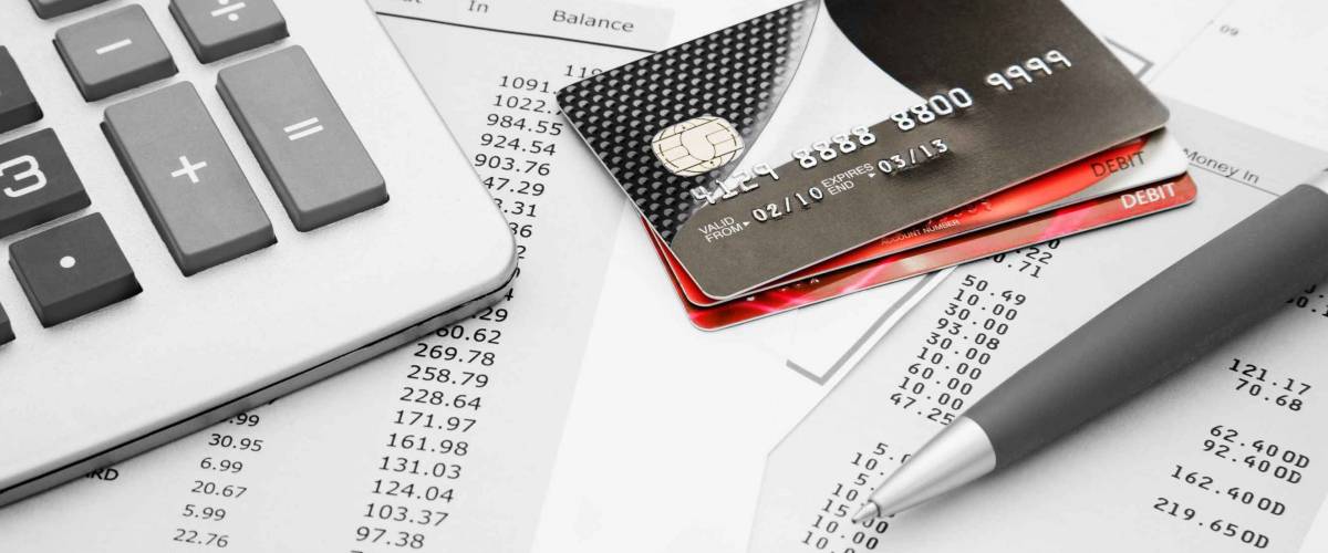 Close up of a credit cards with credit card statements,pen and calculator