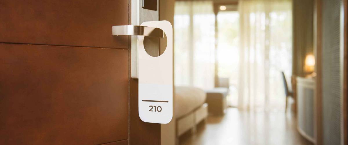 The hotel room with room number sign on the door