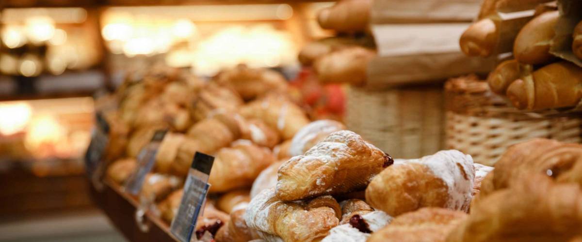 Image of a lot of sweet croissants in supermarket bakery