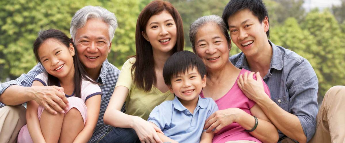 Portrait Of Multi-Generation Chinese Family Relaxing In Park Together