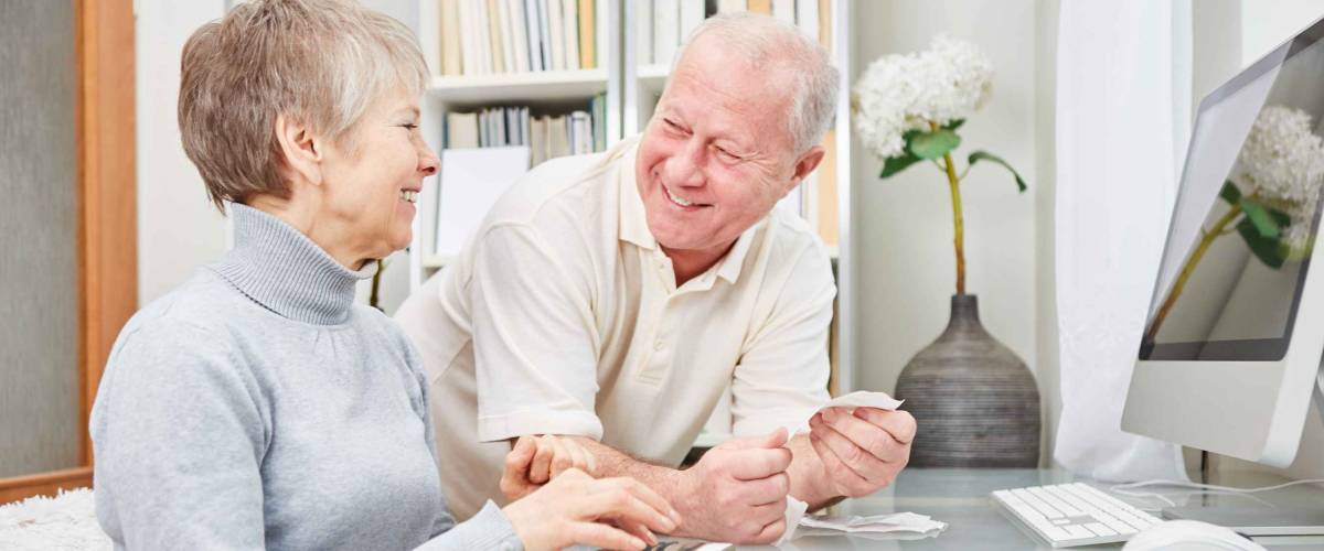 Senior couple of retirees doing accounting at home