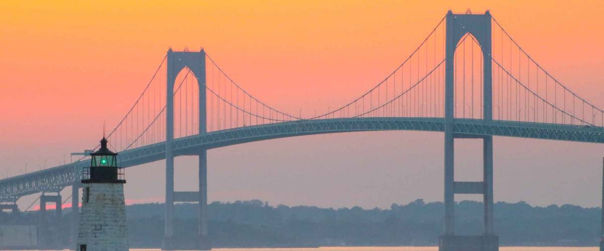 Newport Harbor Lighthouse and the Newport Bridge at sunset