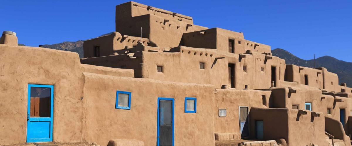 The Taos pueblo in New Mexico features adobe structures stacked atop each other.