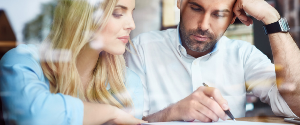 Young couple reading a contract together