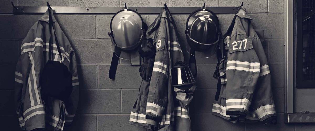 Firefighter gear with fire hoses and truck
