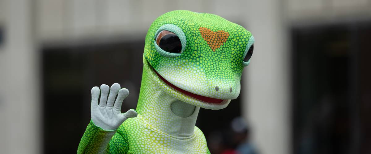 Man wearing the Geico insurance gecko mascot outfit.