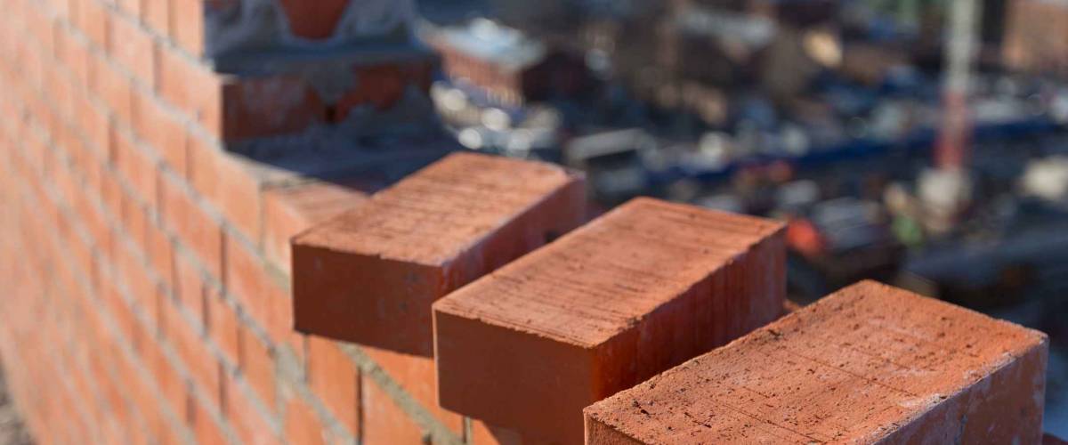Brickwork in the new house with three bricks in the foreground