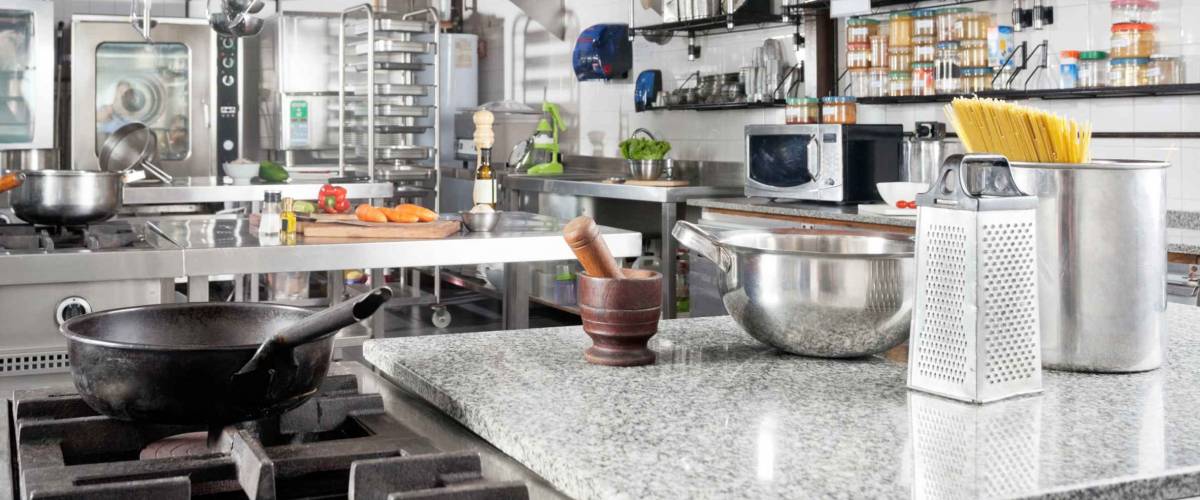 Variety of utensils on counter in commercial kitchen