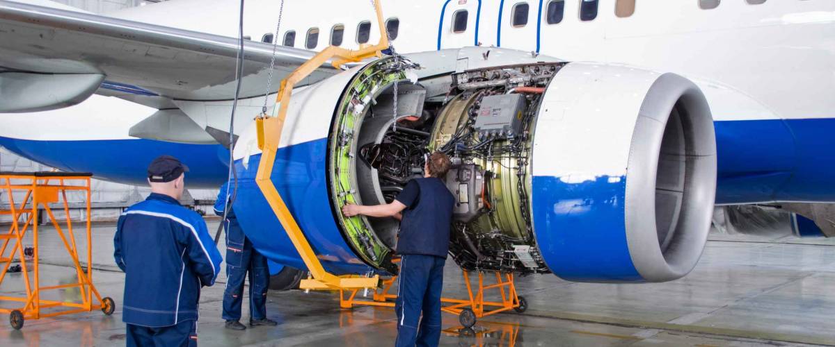Replacing the engine on the airplane, working people. Concept maintenance of aircraft
