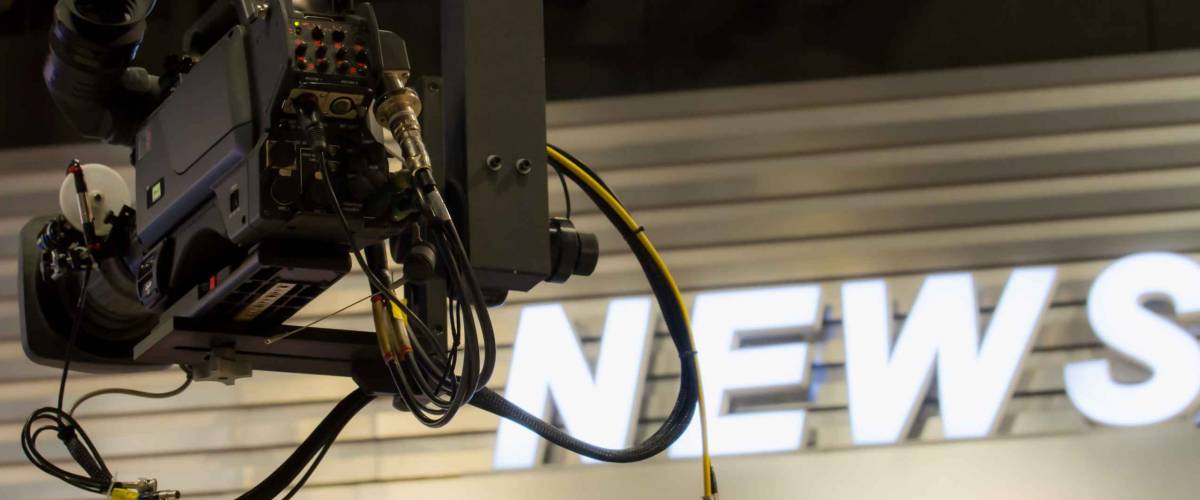 Camera in broadcast news room.