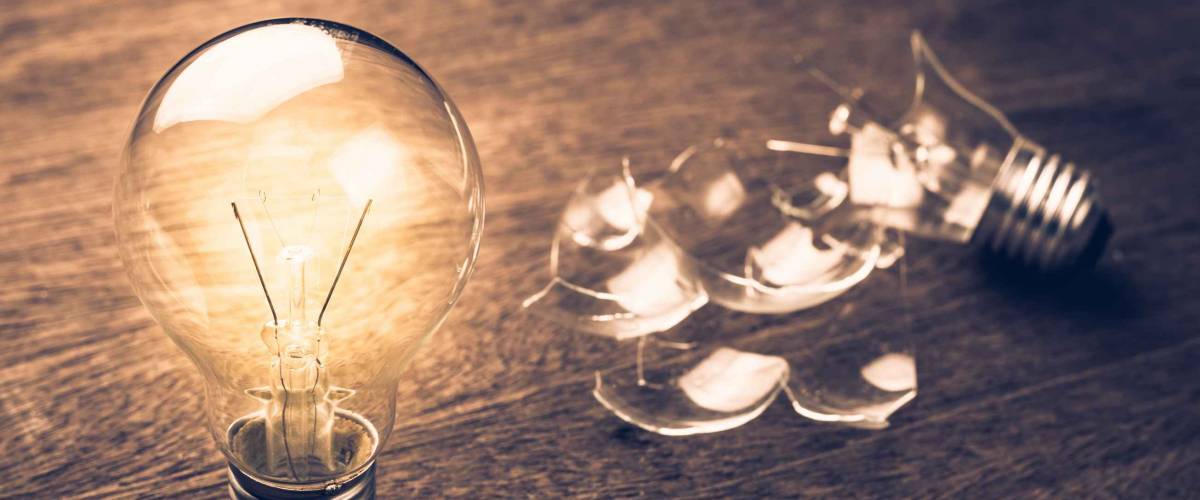 Glowing and broken light bulb comparison concept, problem and solution, failure and success, learning from mistake