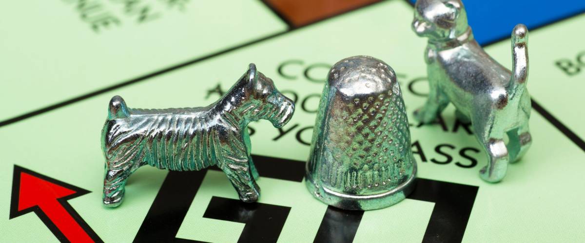 ATLANTA - APRIL 23, 2014: Close up of Monopoly game pieces on board.