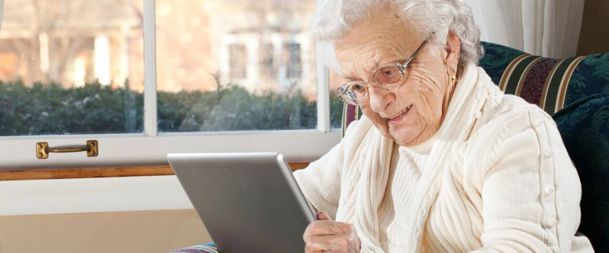 Grandma Using Tablet PC in Living Room