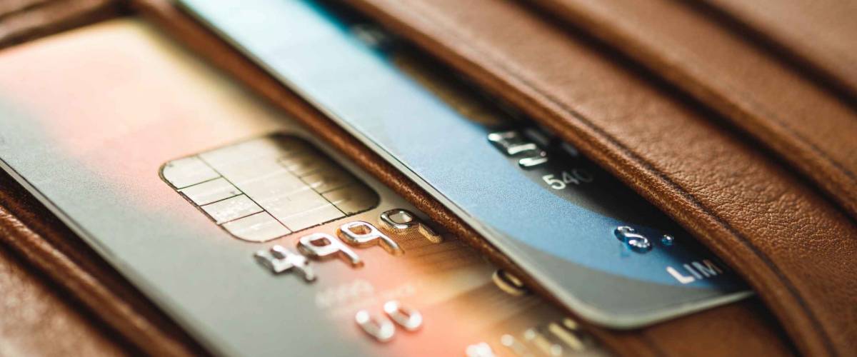 Credit cards in brown wallet in shallow focus