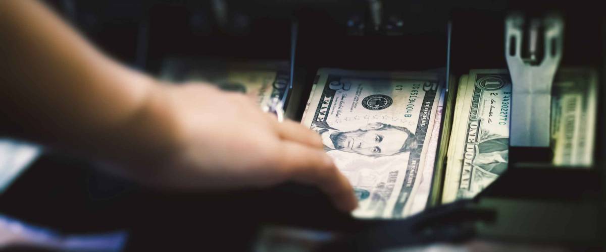 High angle view of cashier searching for change in cash.