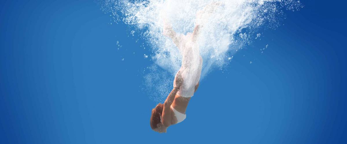 Young woman swimming undewater in the swimming pool