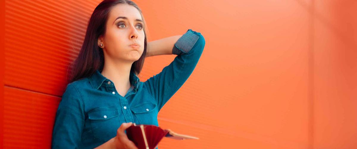 Unhappy Female Customer Having No More Money to Spend. Poor broke girl having financial problems while shopping