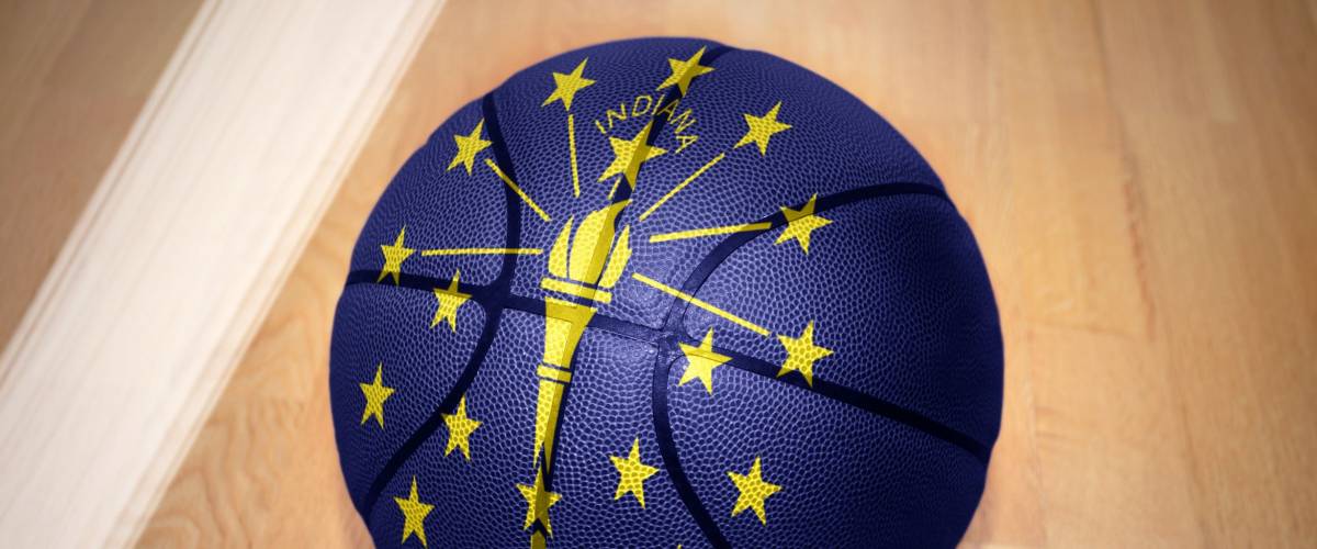 basketball ball with the flag of indiana state lying on the floor near the white line