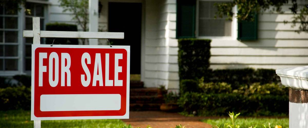 For sale sign outside a family house