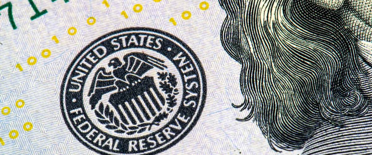 macro photo of federal reserve system symbol on hundred dollar bill, shallow focus