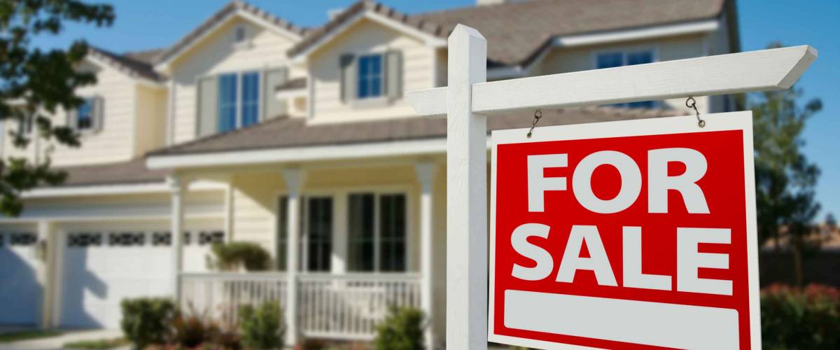 Home For Sale Real Estate Sign in Front of New House.