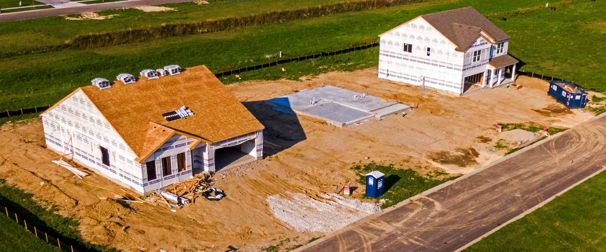 Two single-family homes under construction side by side in McHenry, Illinois