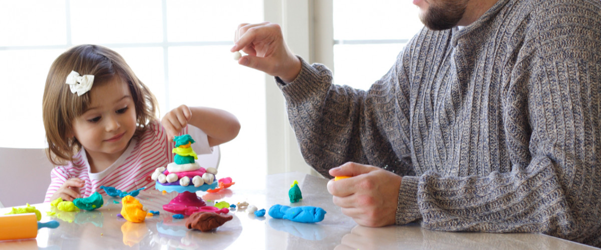 Little girl playing with putty