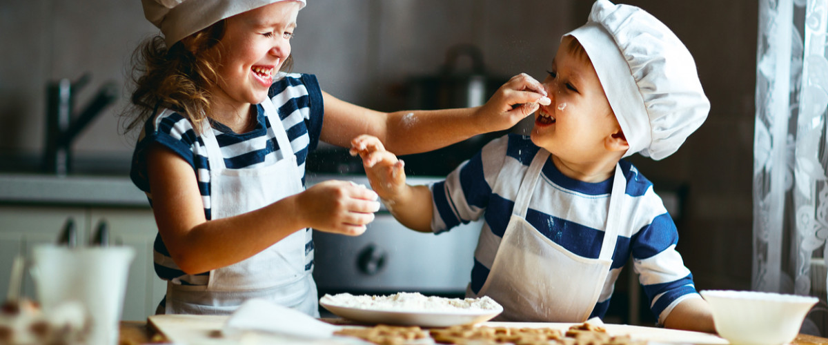 happy family funny kids are preparing the dough, bake cookies in the kitchen