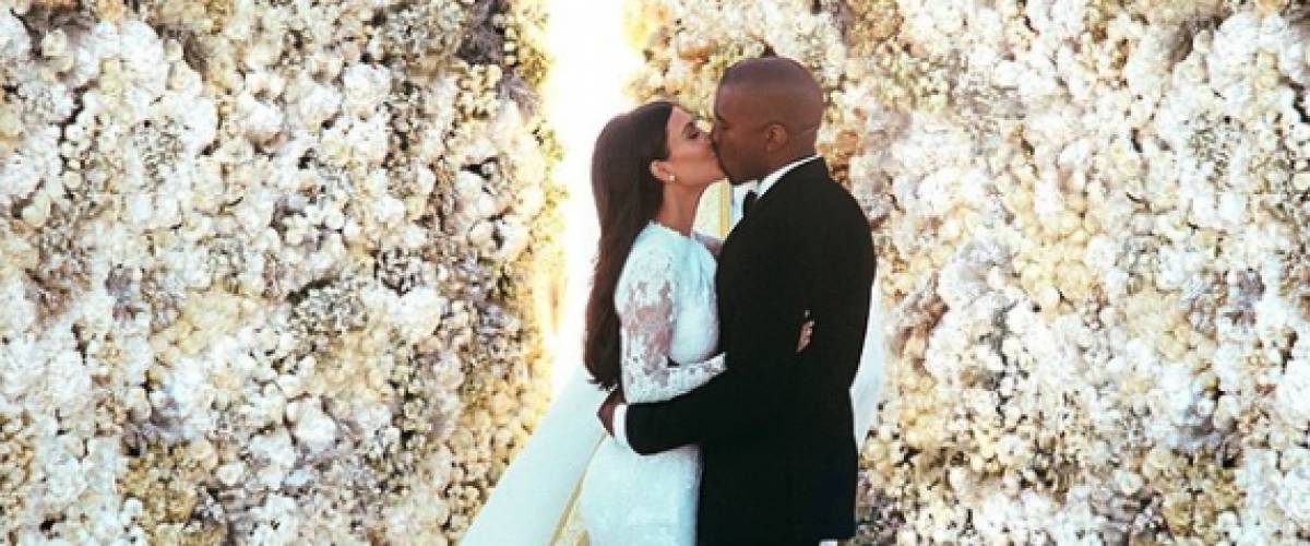 Kanye West nd Kim Kardashian share a wedding kiss.
