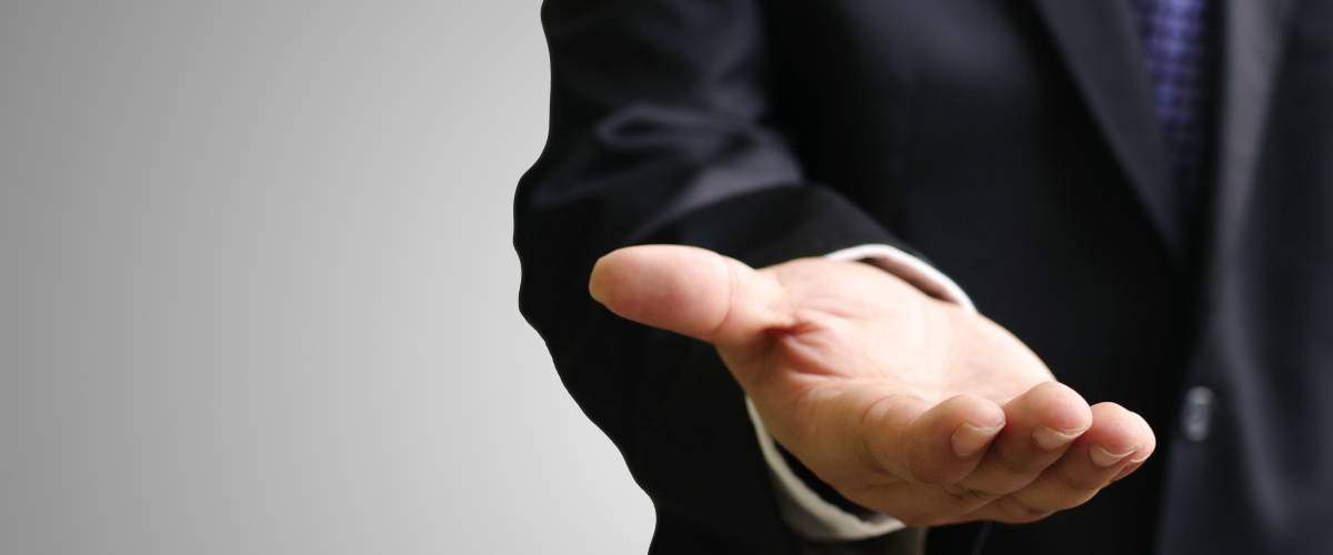 Businessman in a suit with his hand out for money