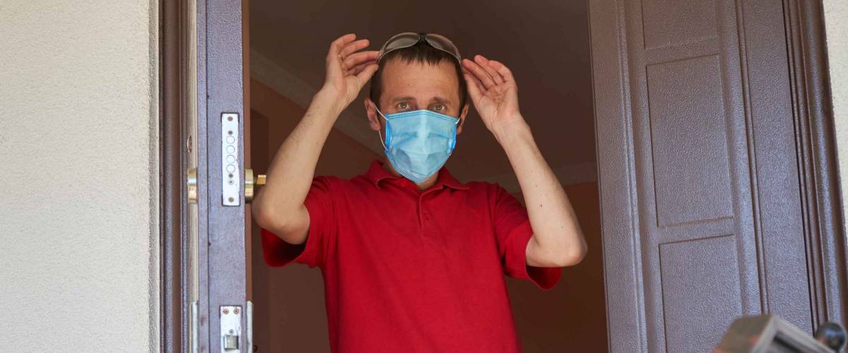 guy goes for a walk in a medical mask,young man leaves home in medical mask
