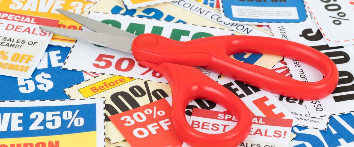 Saving discount coupon voucher with scissor, coupons are mock-up
