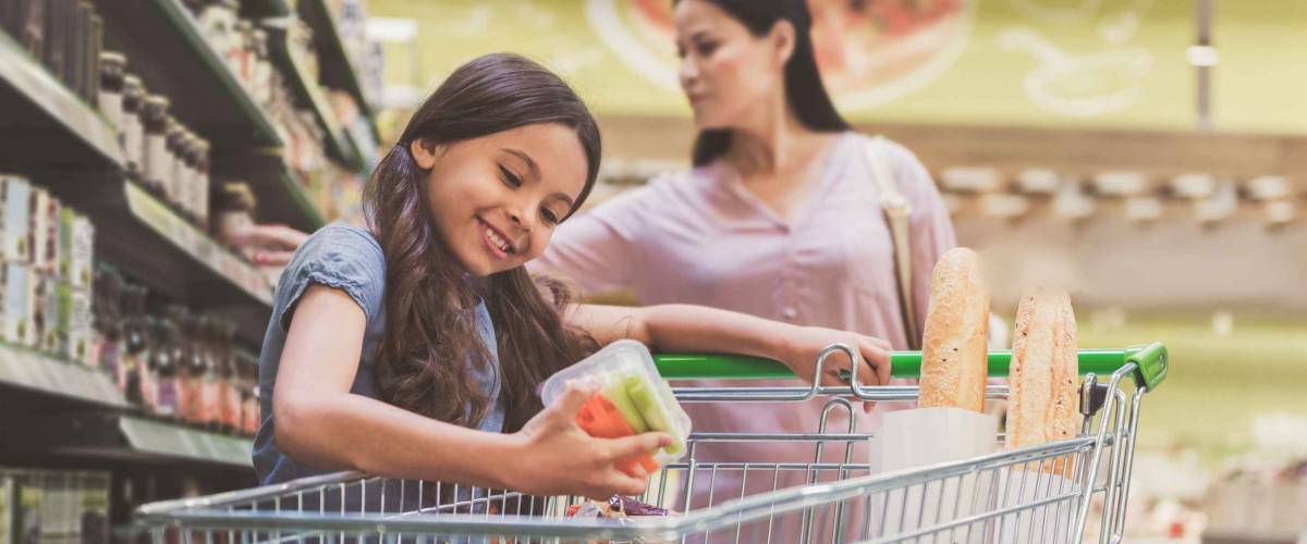 Cheerful child watching at products